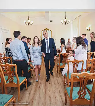 Couple walking down the aisle at the Woolwich Registry Office