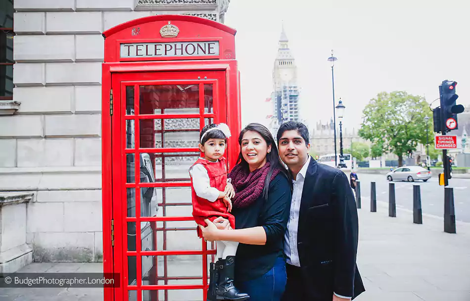 Family with a red phone booth
