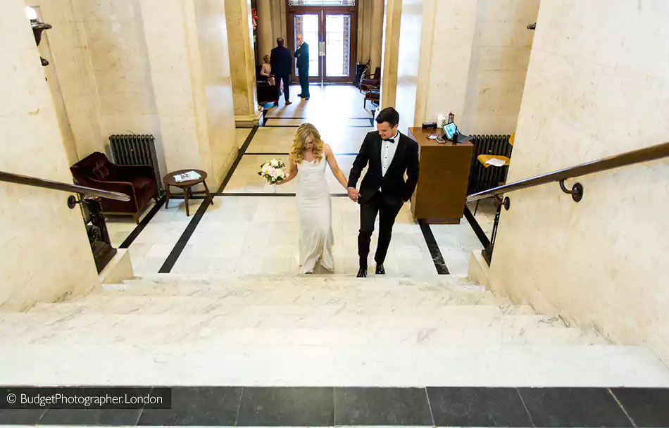 Couple walking up the stairs at Marylebone Town Hall