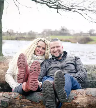 Couple sitting on logs