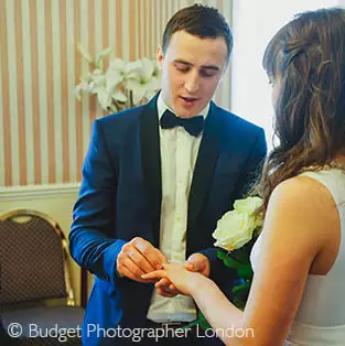 Groom putting on the ring