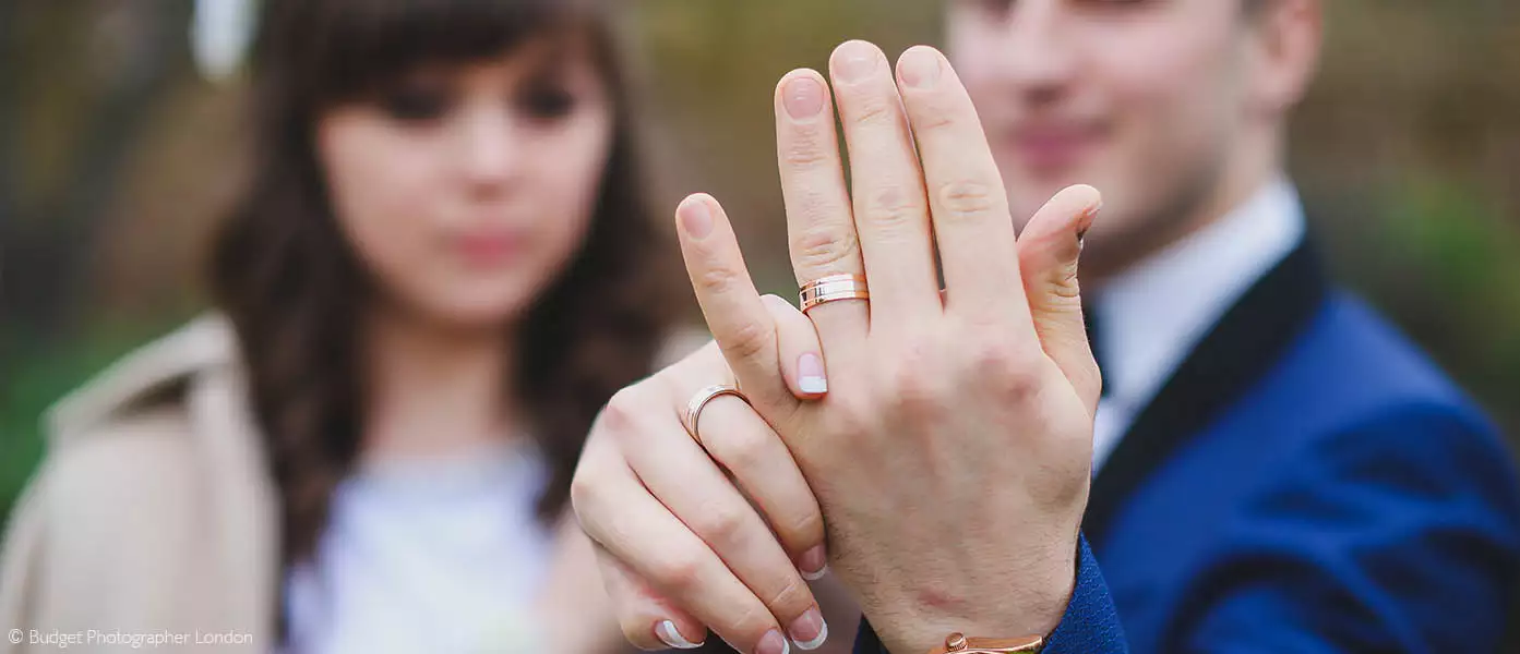 The newly weds showing their marriage bands